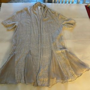 Chicos very unique sweater. It is tan ribbed with opaque inserts.